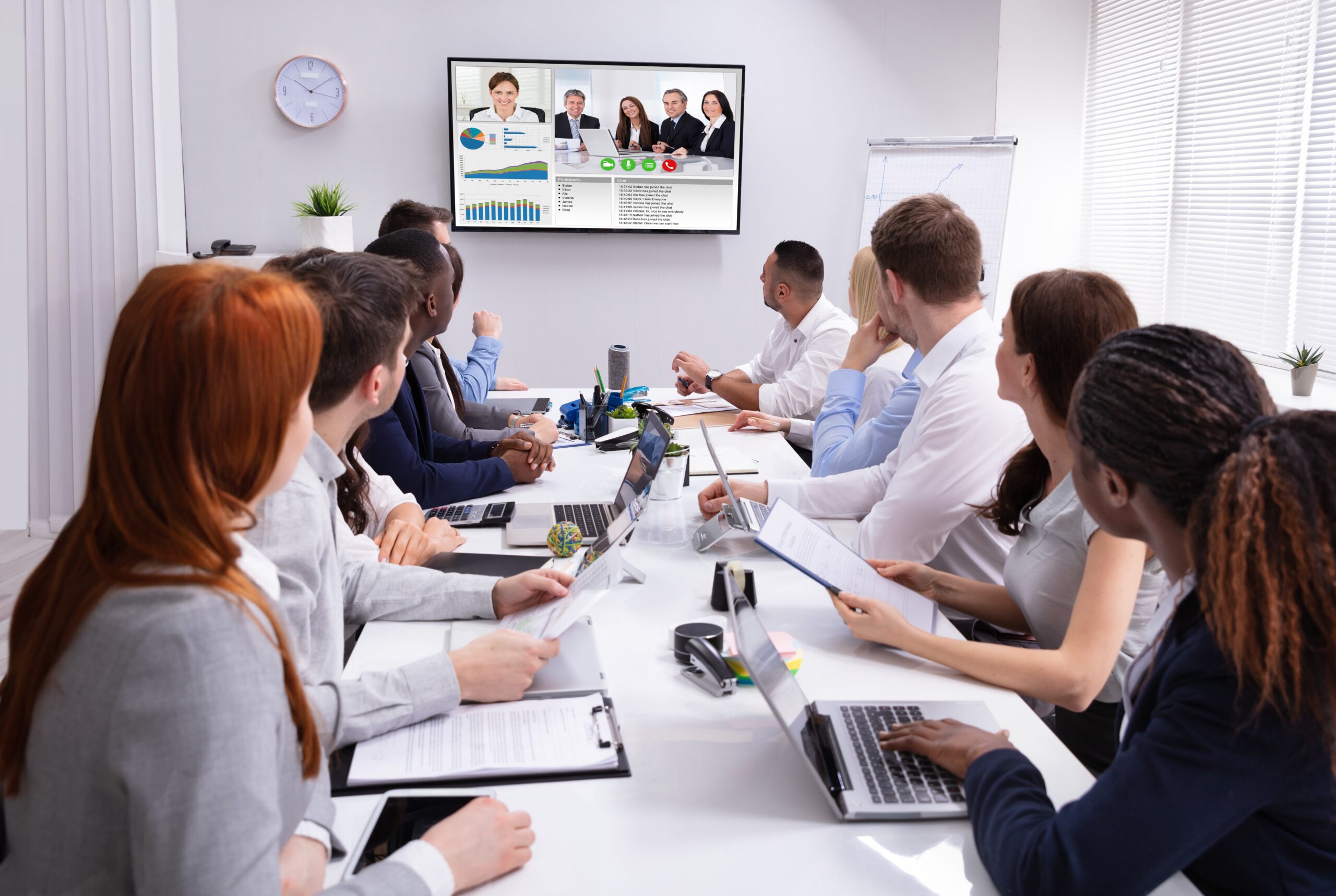 Businesspeople Having Video Conference In Boardroom